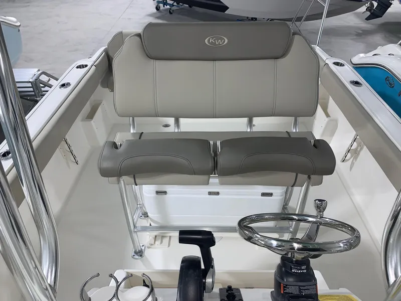 Slide: The Image of 2024 Key West 239 FS boat interior with dual seats and steering console. - 10