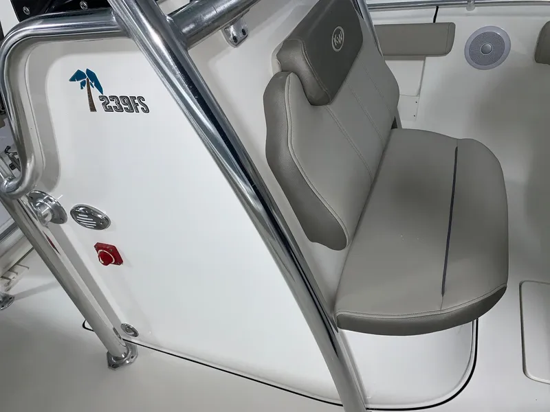 Slide: The Image of 2024 Key West 239 FS boat interior with cushioned seating and stainless steel railing. - 13