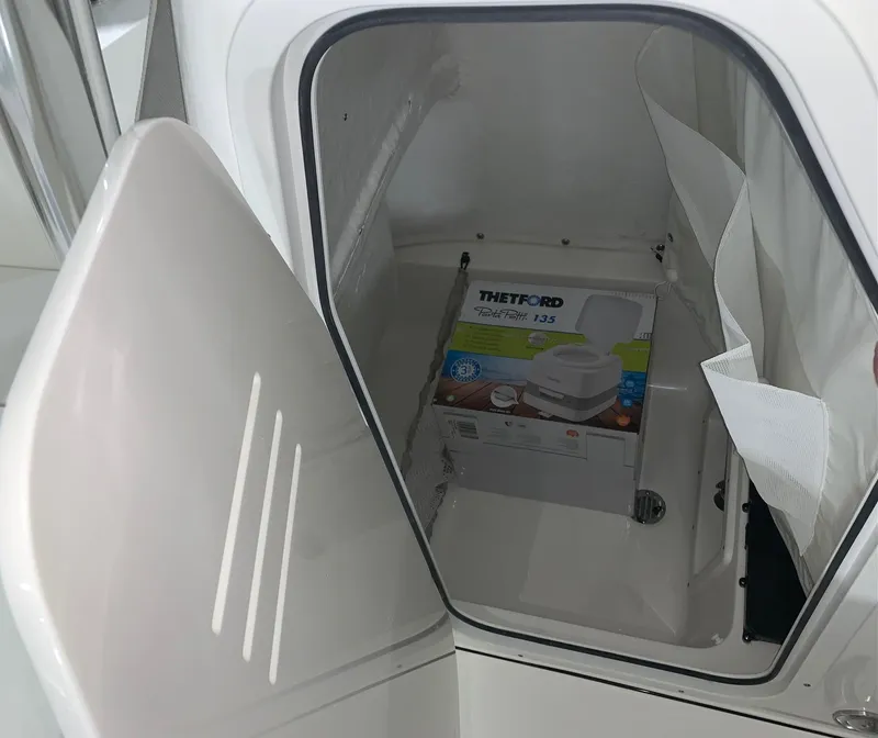 Slide: The Image of 2024 Key West 239 FS storage compartment with Thetford Porta Potti 135. - 9