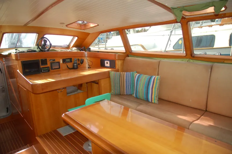 Slide: The Image of Interior of 2000 Garcia 48 Raised Salon yacht with wooden furnishings and striped cushions. - 60