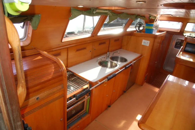 Slide: The Image of Interior of 2000 Garcia 48 Raised Salon yacht with wooden cabinetry and modern kitchen amenities. - 54