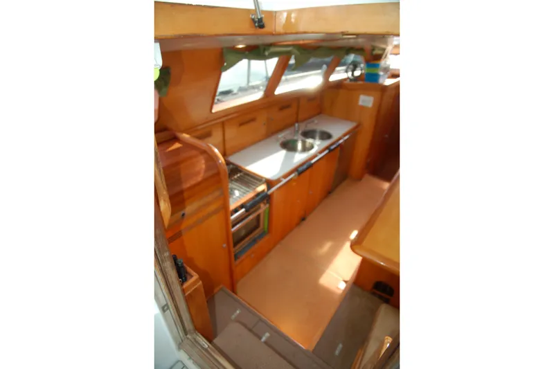Slide: The Image of Interior of 2000 Garcia 48 Raised Salon yacht with wooden cabinetry and modern kitchen amenities. - 53