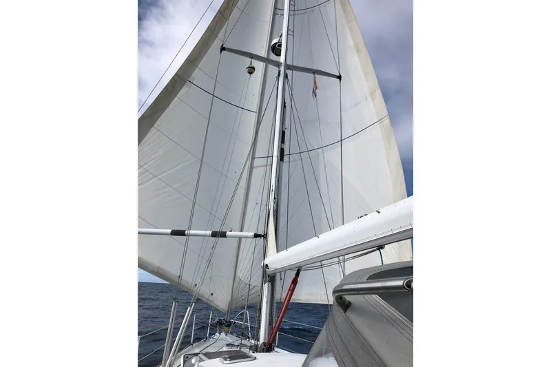 Slide: The Image of Sailing on a 2000 Garcia 48 Raised Salon yacht with full sails against a cloudy sky. - 84