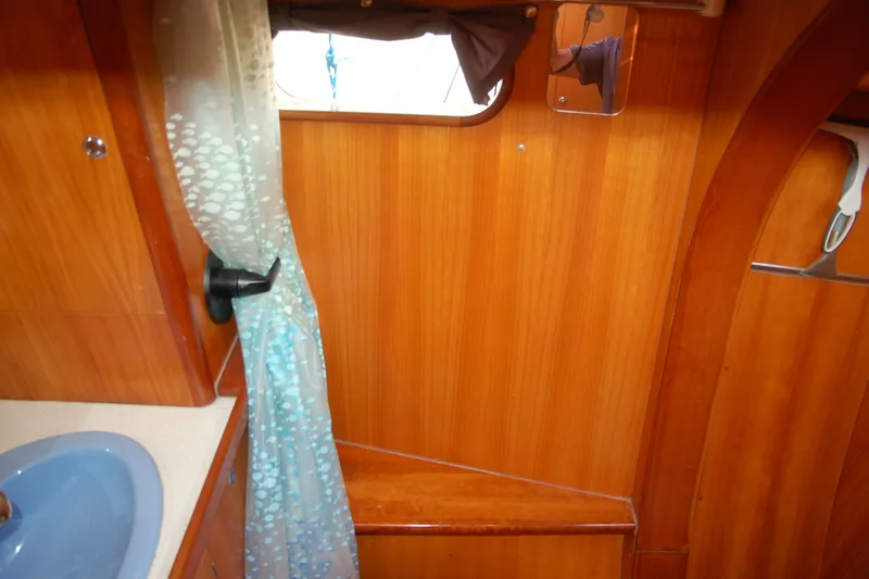 Slide: The Image of Interior of 2000 Garcia 48 Raised Salon yacht with wooden paneling and blue sink. - 65