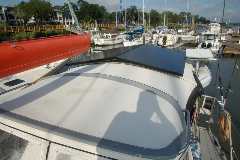 Slide: The Image of 2000 Garcia 48 Raised Salon yacht docked at marina with solar panels. - 22