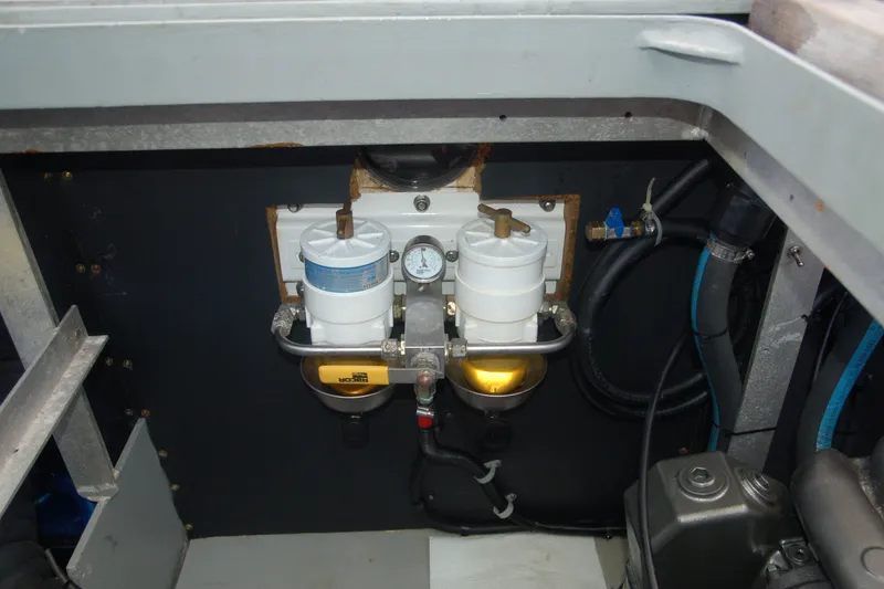 Slide: The Image of Engine compartment of 2000 Garcia 48 Raised Salon yacht, featuring dual fuel filters and gauge. - 40