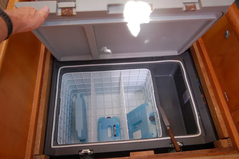 Slide: The Image of Open freezer compartment in Garcia 48 Raised Salon yacht, showcasing storage space and ice packs. - 79