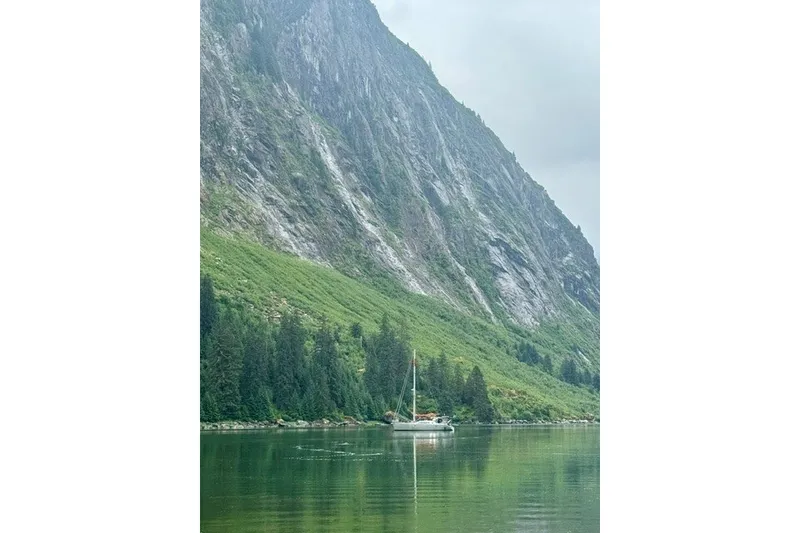 Slide: The Image of Sailboat "Garcia 48 Raised Salon" on serene lake with lush mountain backdrop. - 80