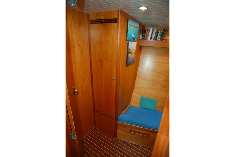 Slide: The Image of Cozy wooden interior of 2000 Garcia 48 Raised Salon yacht with seating and bookshelf. - 69