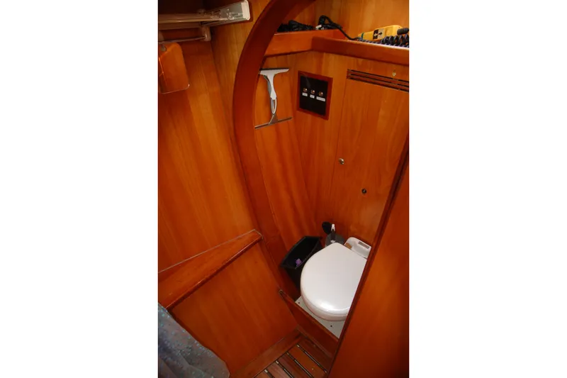 Slide: The Image of Wood-paneled bathroom in 2000 Garcia 48 Raised Salon yacht, featuring compact toilet. - 63