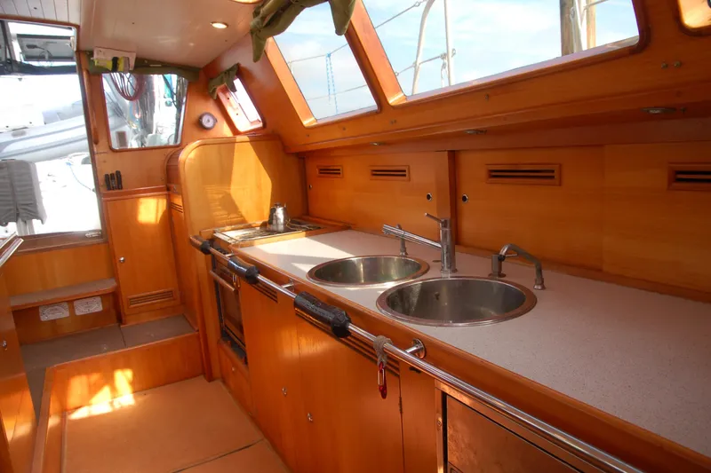 Slide: The Image of Interior of 2000 Garcia 48 Raised Salon yacht with wooden cabinetry and dual sinks. - 77
