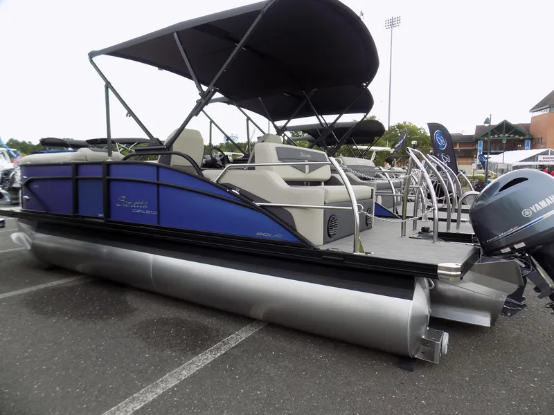 Slide: The Image of 2023 Barletta C20UC pontoon boat with canopy, displayed outdoors. - 4
