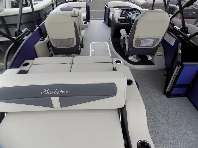 Slide: The Image of 2023 Barletta C20UC pontoon boat interior with beige seating and modern dashboard. - 9