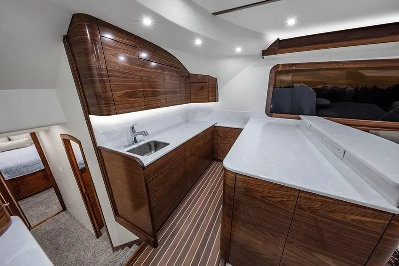 Slide: The Image of Luxurious 2026 Albemarle 53 Spencer yacht interior with modern kitchen and sleek wood finishes. - 4