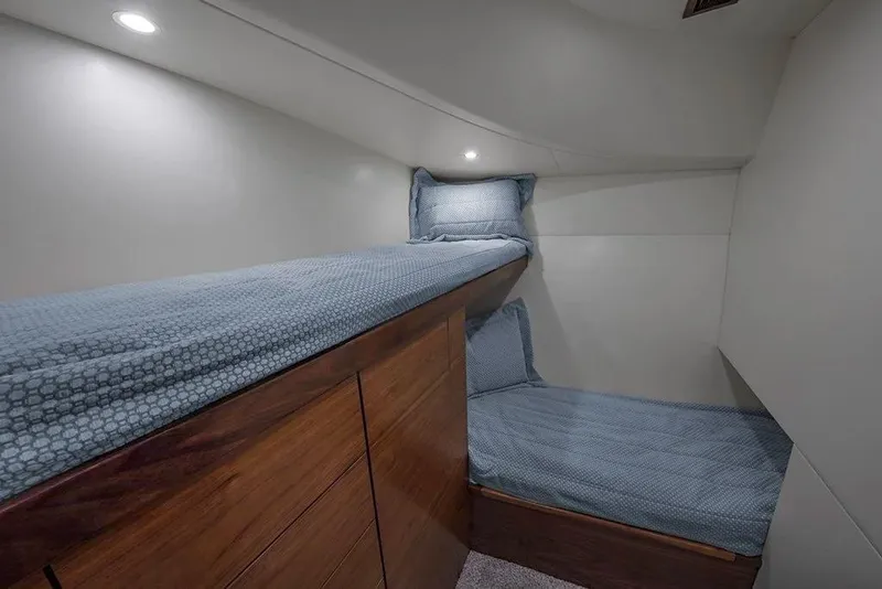 Slide: The Image of 2026 Albemarle 53 Spencer yacht cabin with cozy twin beds and modern lighting. - 6
