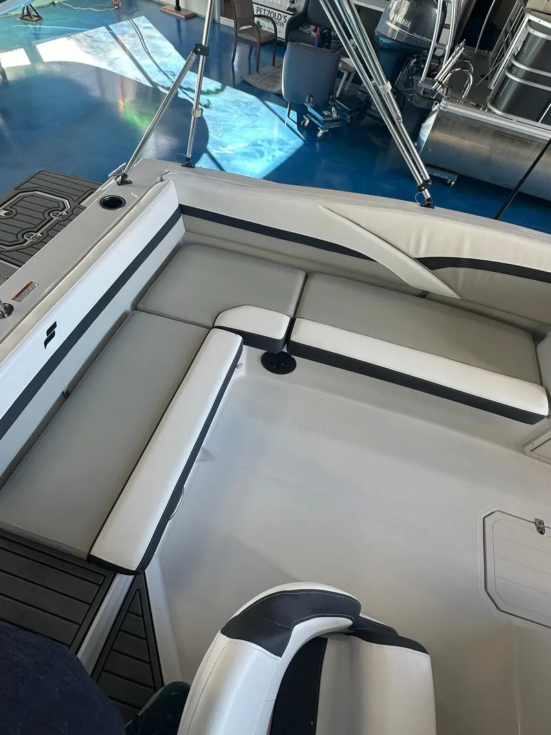 Slide: The Image of 2026 Starcraft SVX 191 OB boat interior with gray seating and cup holders. - 10
