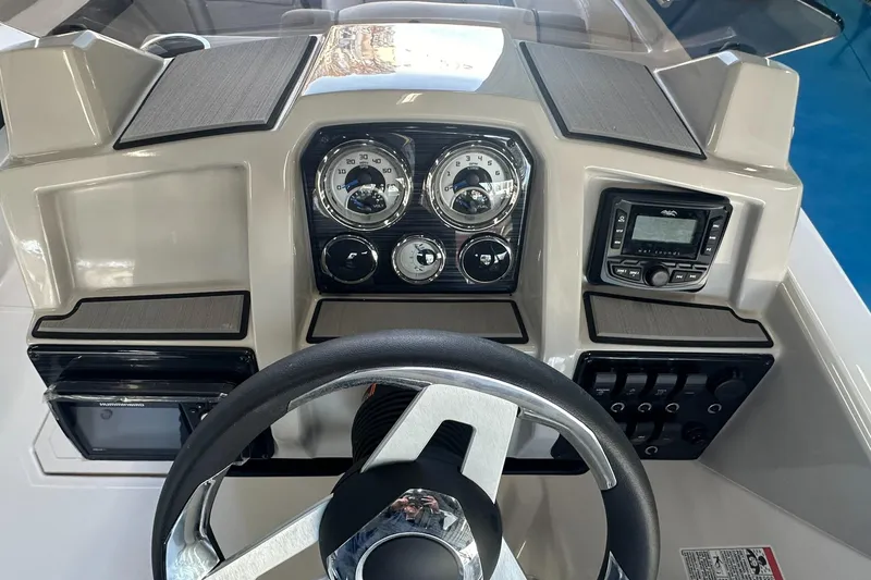 Slide: The Image of 2026 Starcraft SVX 191 OB boat interior with seating, steering console, and table. - 17