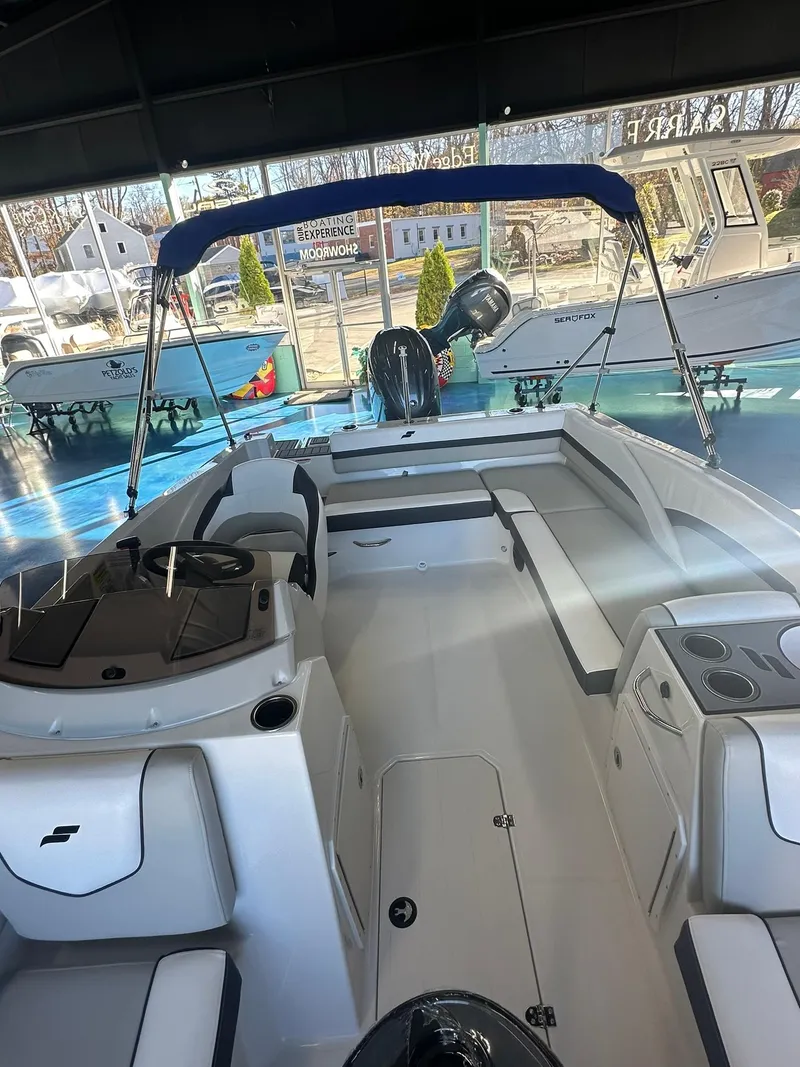 Slide: The Image of 2026 Starcraft SVX 191 OB boat interior with sleek seating and central table. - 21