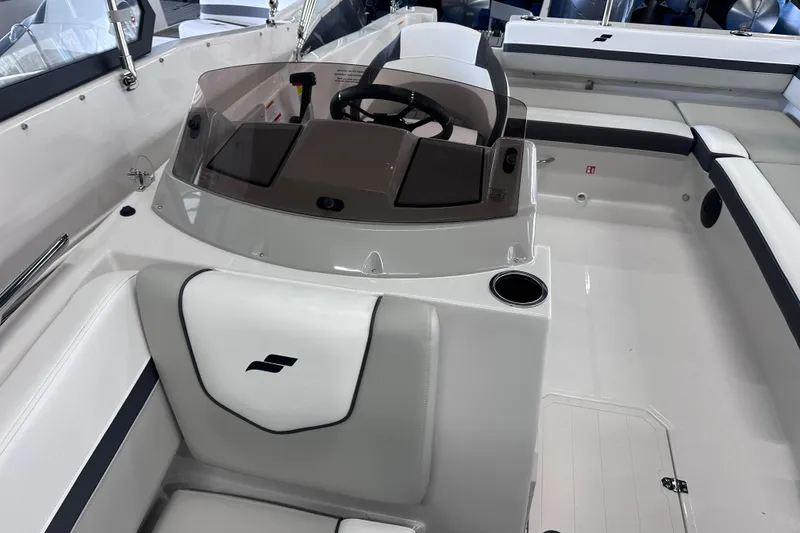 Slide: The Image of 2026 Starcraft SVX 191 OB boat interior with steering console and seating area. - 26