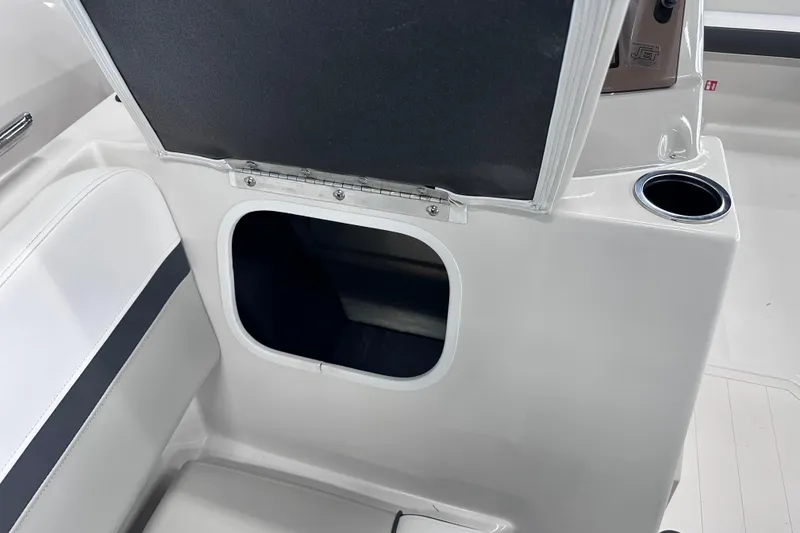 Slide: The Image of 2026 Starcraft SVX 191 OB boat interior with storage compartment and cup holder. - 27
