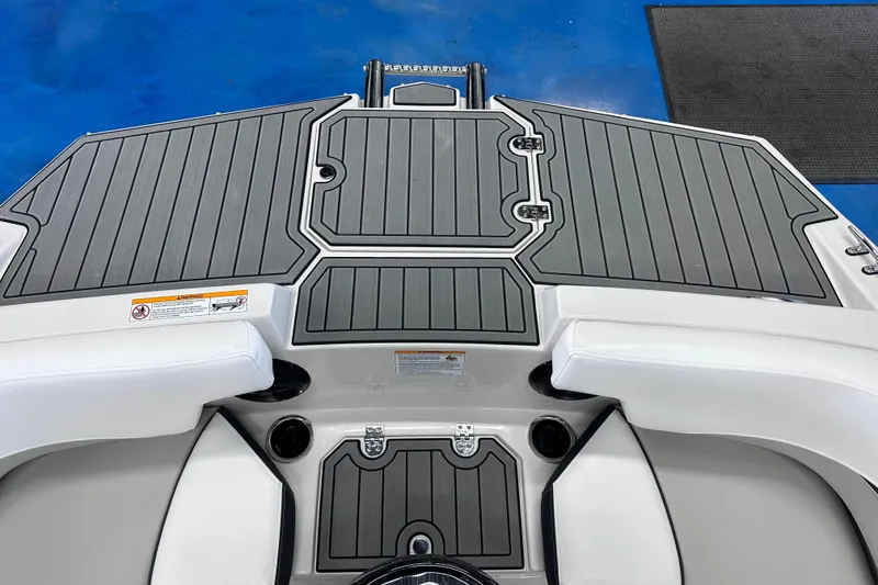 Slide: The Image of 2026 Starcraft SVX 191 OB boat deck with gray non-slip surface and white seating. - 28