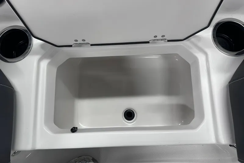 Slide: The Image of 2026 Starcraft SVX 191 OB boat storage compartment with cup holders. - 29