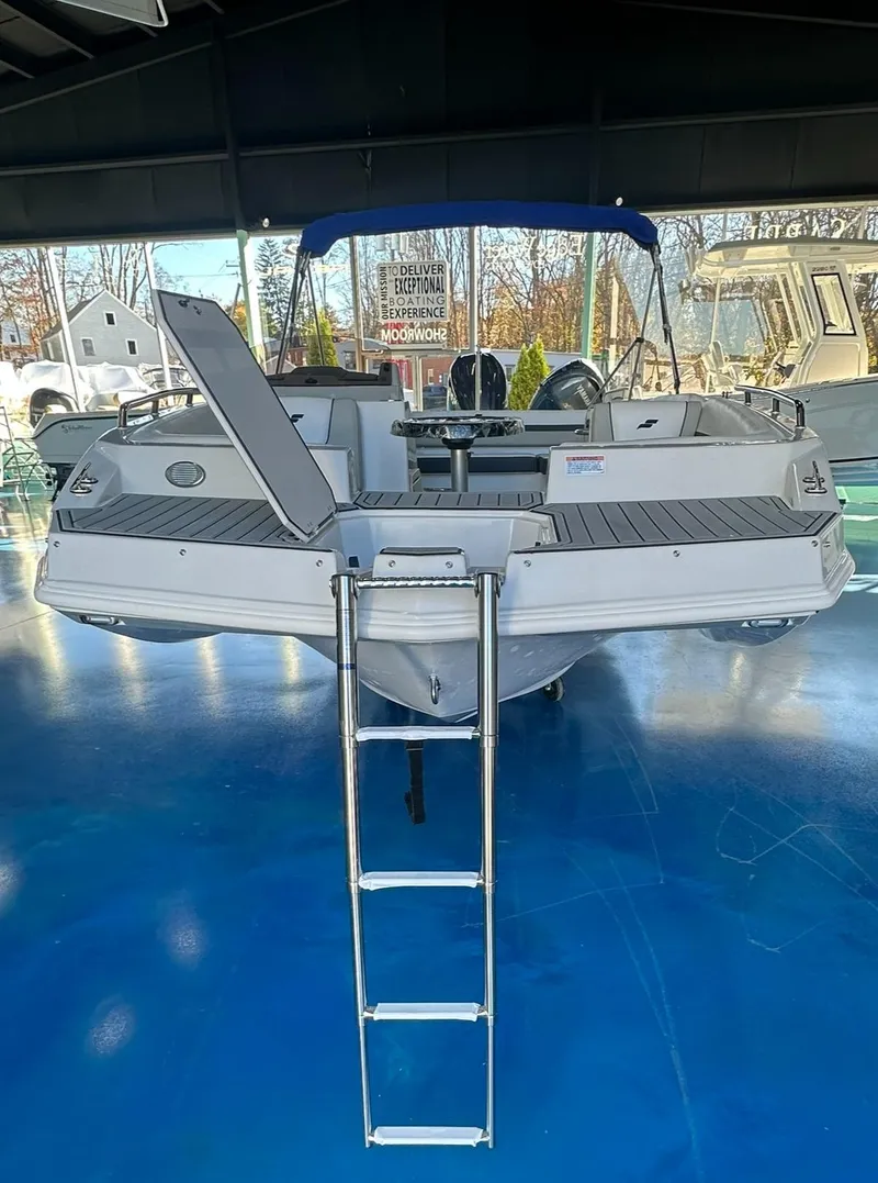 Slide: The Image of 2026 Starcraft SVX 191 OB boat displayed in a showroom. - 3