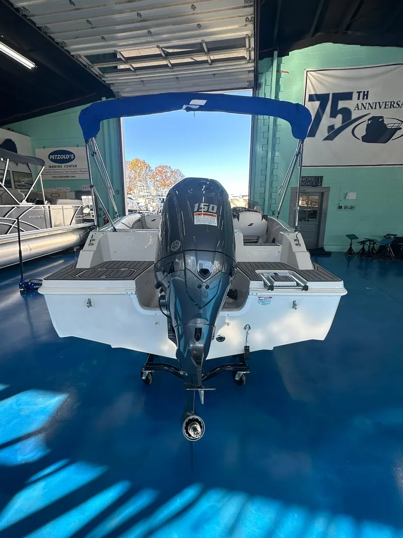 Slide: The Image of 2026 Starcraft SVX 191 OB boat interior with modern seating and steering console. - 7