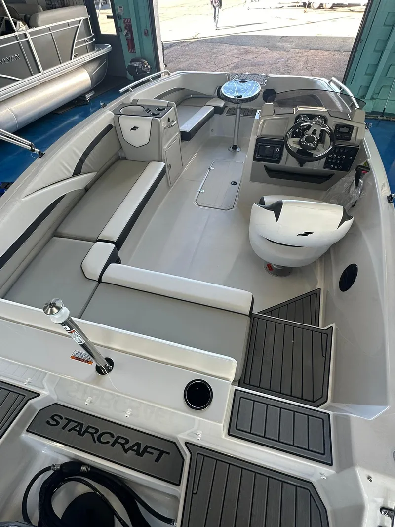 Slide: The Image of 2026 Starcraft SVX 191 OB boat interior storage compartment with packaging inside. - 9