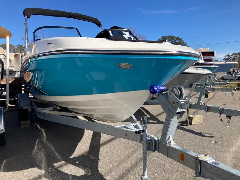 Slide: The Image of 2024 Bayliner VR5 boat on trailer, blue hull, sunny day. - 1
