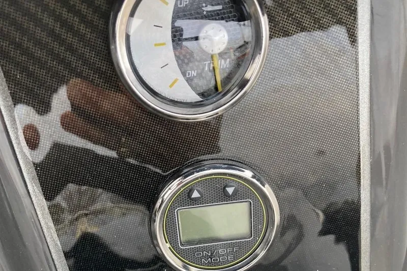 Slide: The Image of Close-up of 2024 Bayliner VR5 boat dashboard with trim gauge and digital display. - 10