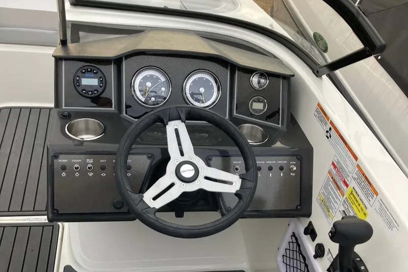 Slide: The Image of 2024 Bayliner VR5 boat dashboard with steering wheel and instrument panel. - 12