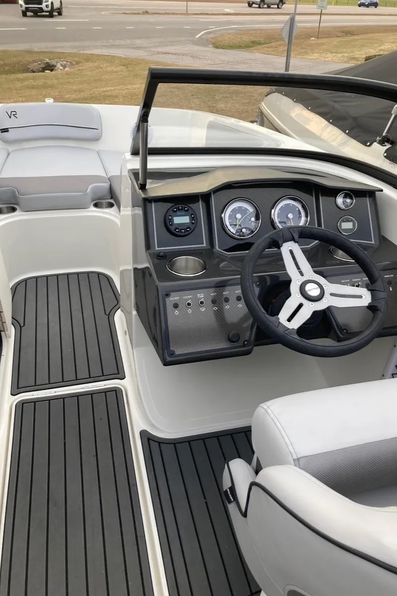 Slide: The Image of 2024 Bayliner VR5 boat interior with steering wheel and dashboard. - 13