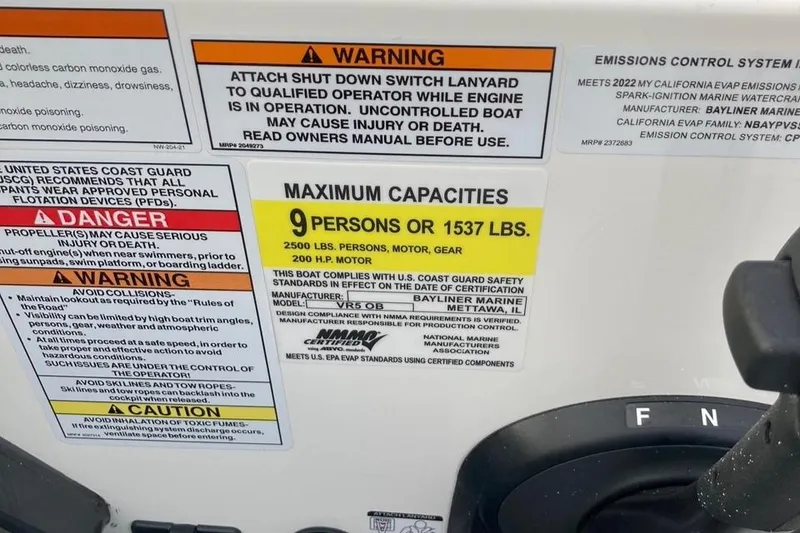 Slide: The Image of 2024 Bayliner VR5 boat capacity and safety warning labels. - 14