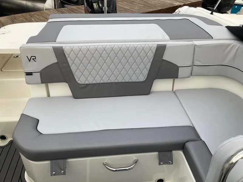 Slide: The Image of 2024 Bayliner VR5 boat interior seating with gray and white upholstery. - 6