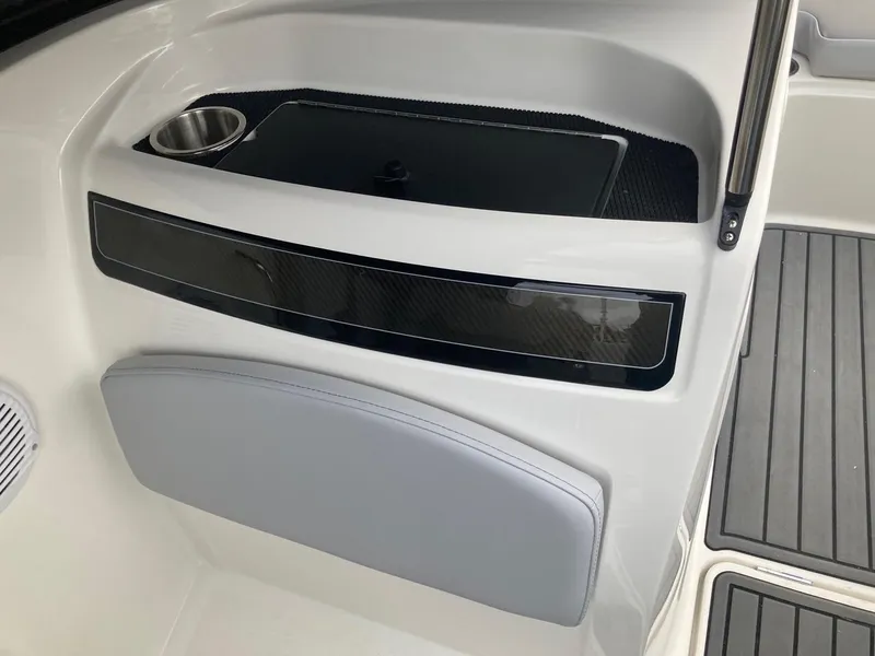 Slide: The Image of 2024 Bayliner VR5 boat interior with cup holder and storage compartment. - 7