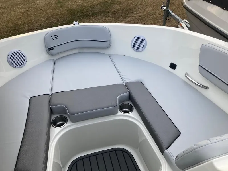 Slide: The Image of 2024 Bayliner VR5 boat interior with cushioned seating and cup holders. - 8