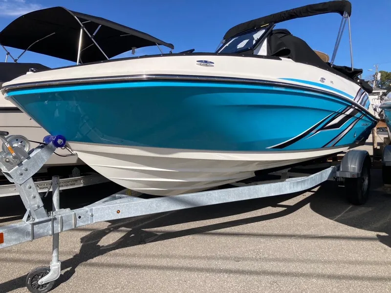 Slide: The Image of 2024 Bayliner VR5 boat on a trailer, blue and white hull, sunny day. - 0