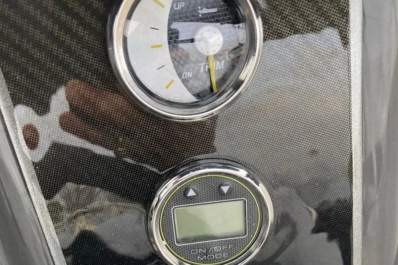 Slide: The Image of Close-up of 2024 Bayliner VR5 boat dashboard with trim gauge and digital display. - 10