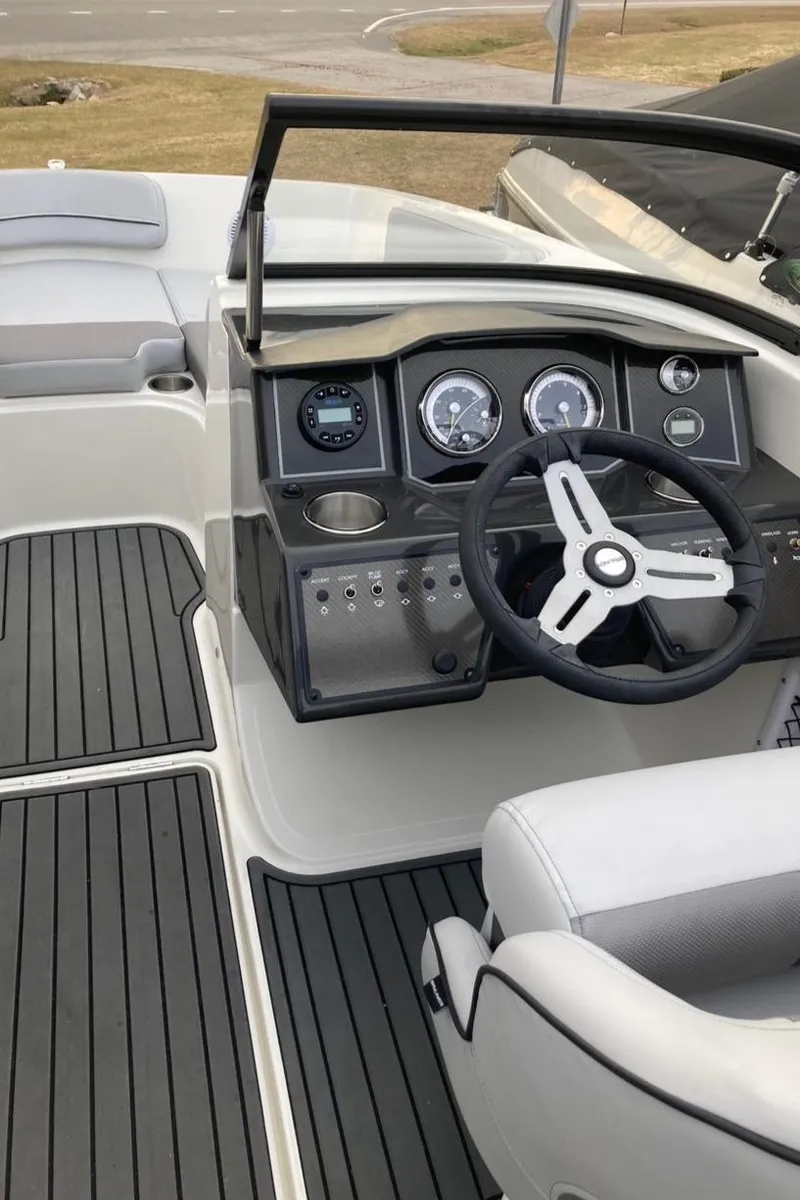 Slide: The Image of 2024 Bayliner VR5 boat cockpit with steering wheel and dashboard. - 12