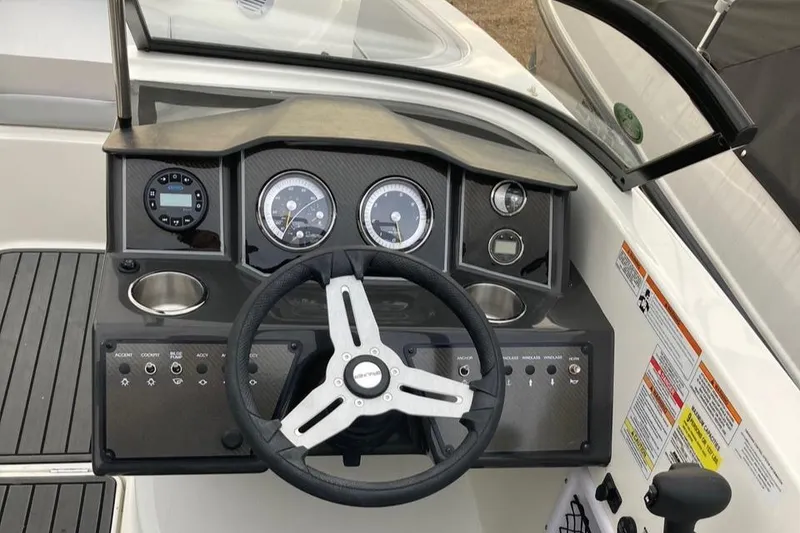 Slide: The Image of 2024 Bayliner VR5 boat dashboard with steering wheel and instrument panel. - 13