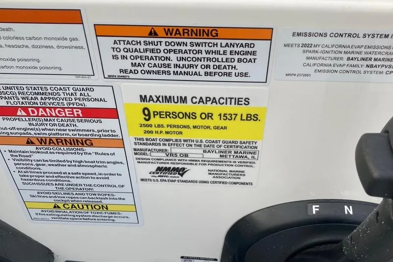 Slide: The Image of 2024 Bayliner VR5 boat capacity and safety warning labels, maximum 9 persons or 1537 lbs. - 14