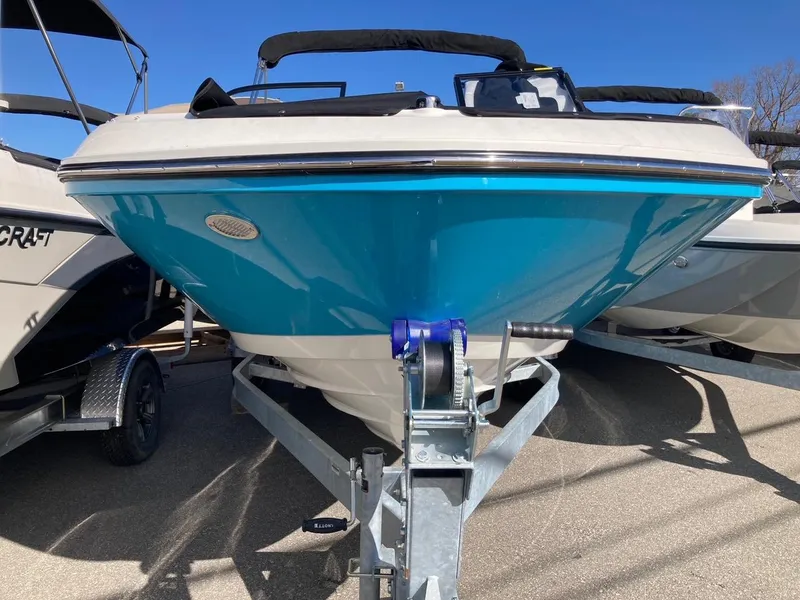 Slide: The Image of 2024 Bayliner VR5 boat on trailer, front view, blue hull, sunny day. - 2