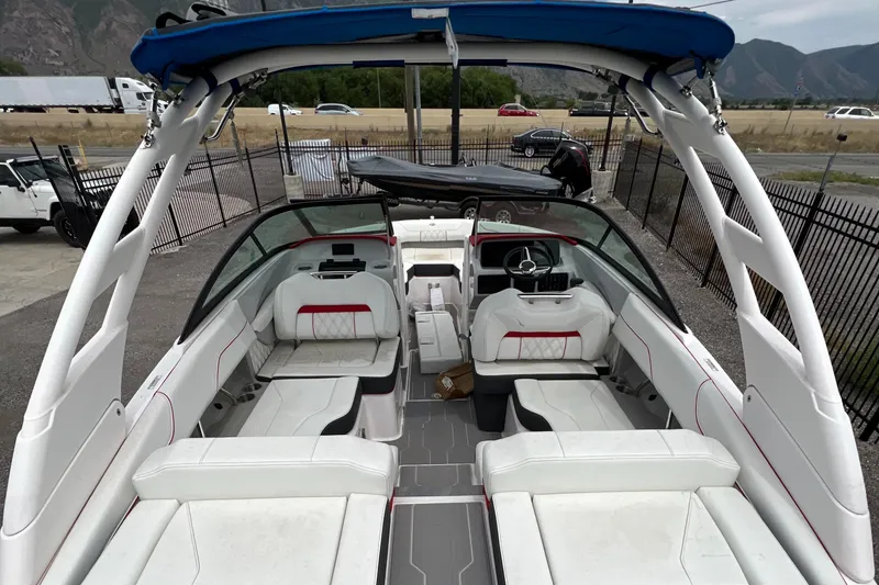 Slide: The Image of 2022 Regal LS2 Surf boat with spacious white interior and modern design. - 10