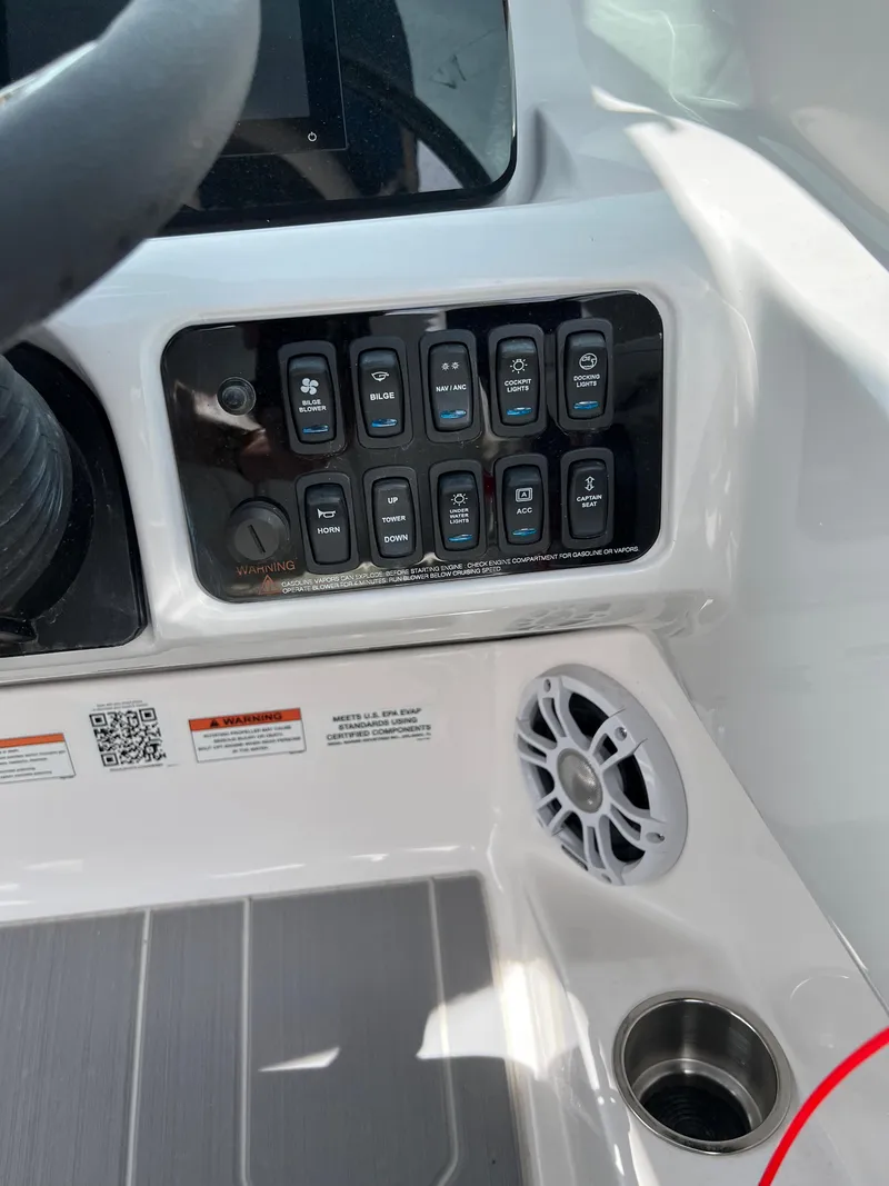 Slide: The Image of Control panel of a 2022 Regal LS2 Surf boat with switches and speaker. - 3