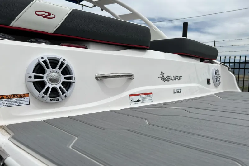 Slide: The Image of 2022 Regal LS2 Surf boat rear deck with speakers and seating. - 5