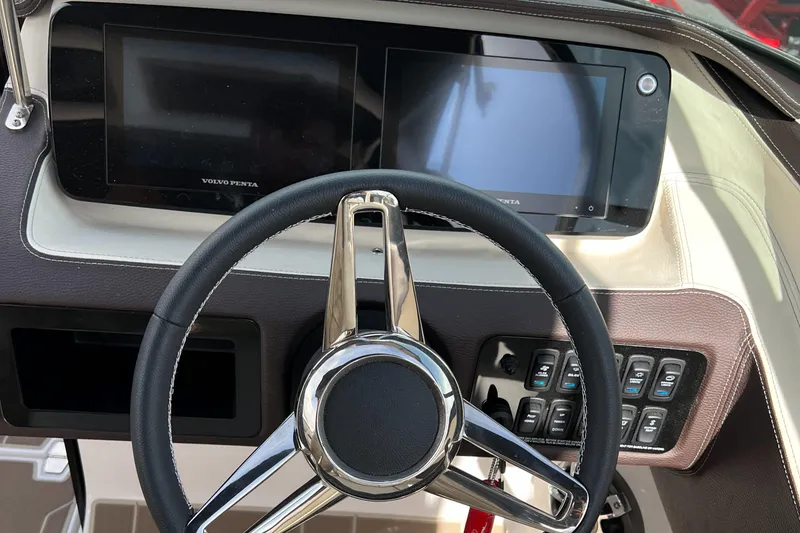 Slide: The Image of 2022 Regal LS6 Surf boat dashboard with steering wheel and digital displays. - 4