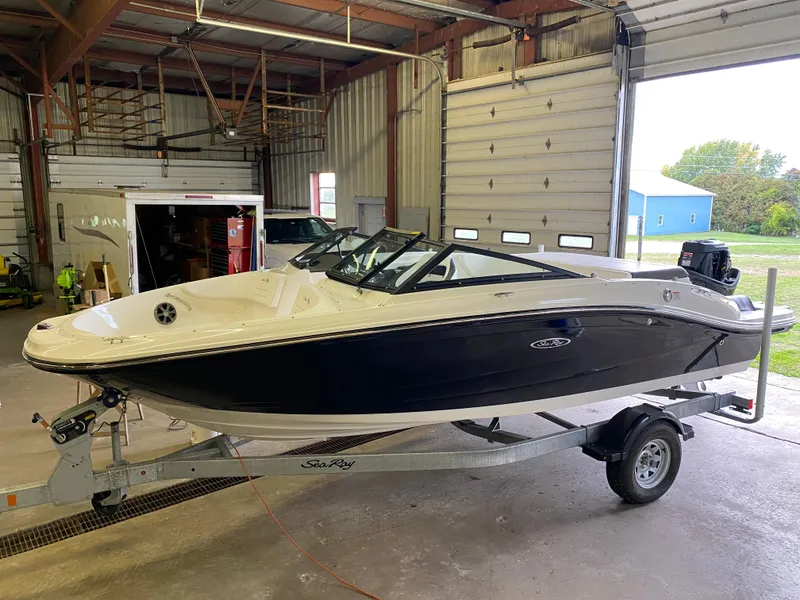 The Image of 2019 Sea Ray 190 SPX BR boat on trailer in indoor storage facility. - 0