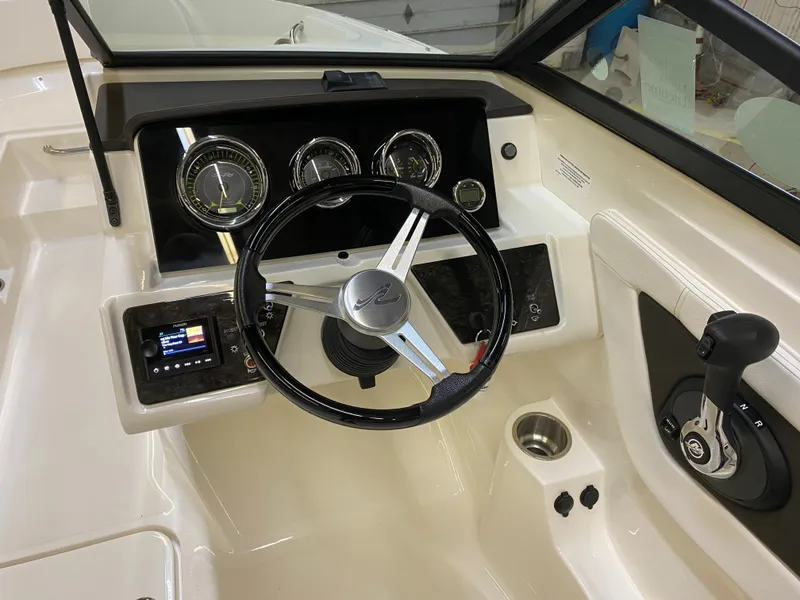 Slide: The Image of 2019 Sea Ray 190 SPX BR boat dashboard with steering wheel and control panel. - 10