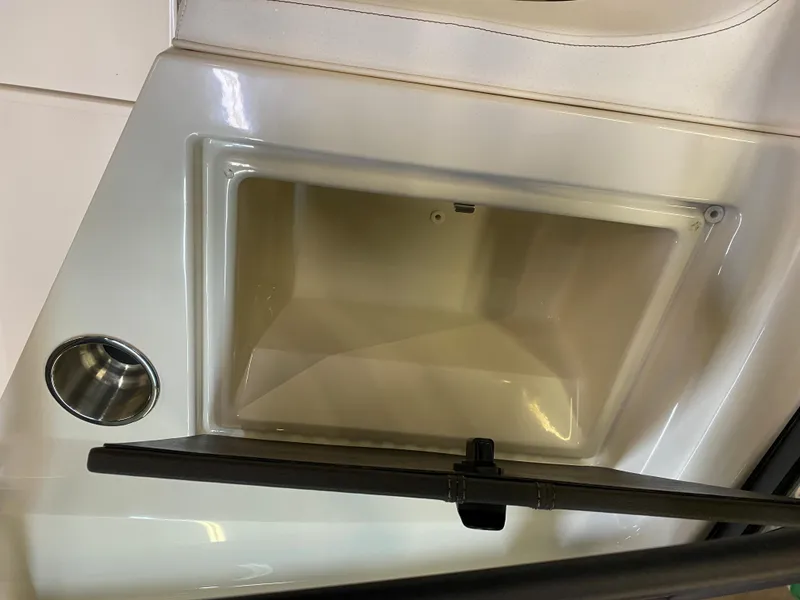 Slide: The Image of 2019 Sea Ray 190 SPX BR boat storage compartment and cup holder. - 17